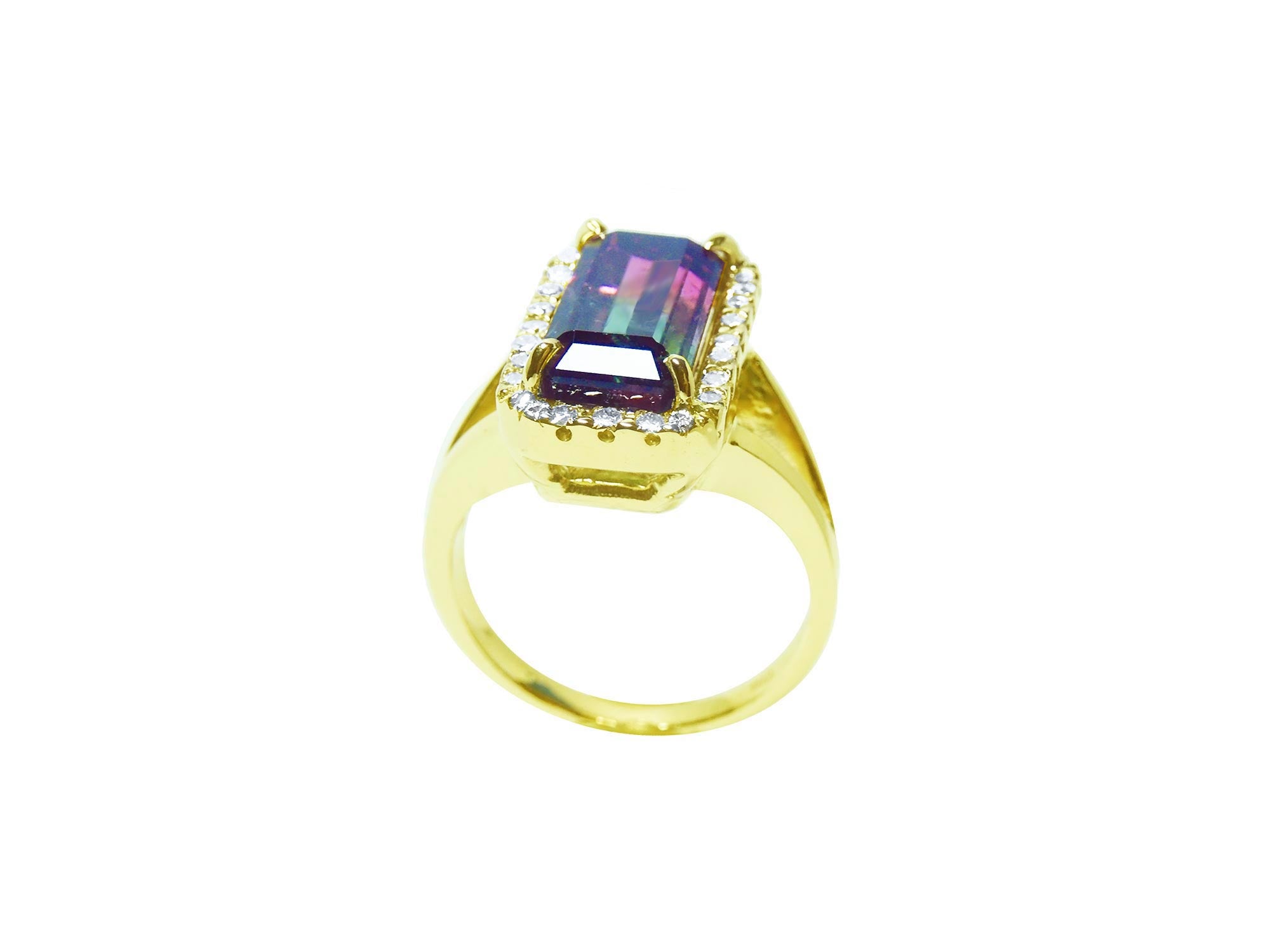 This natural watermelon tourmaline ring with a halo diamond, crafted in 14k yellow gold, is on a lateral profile view.