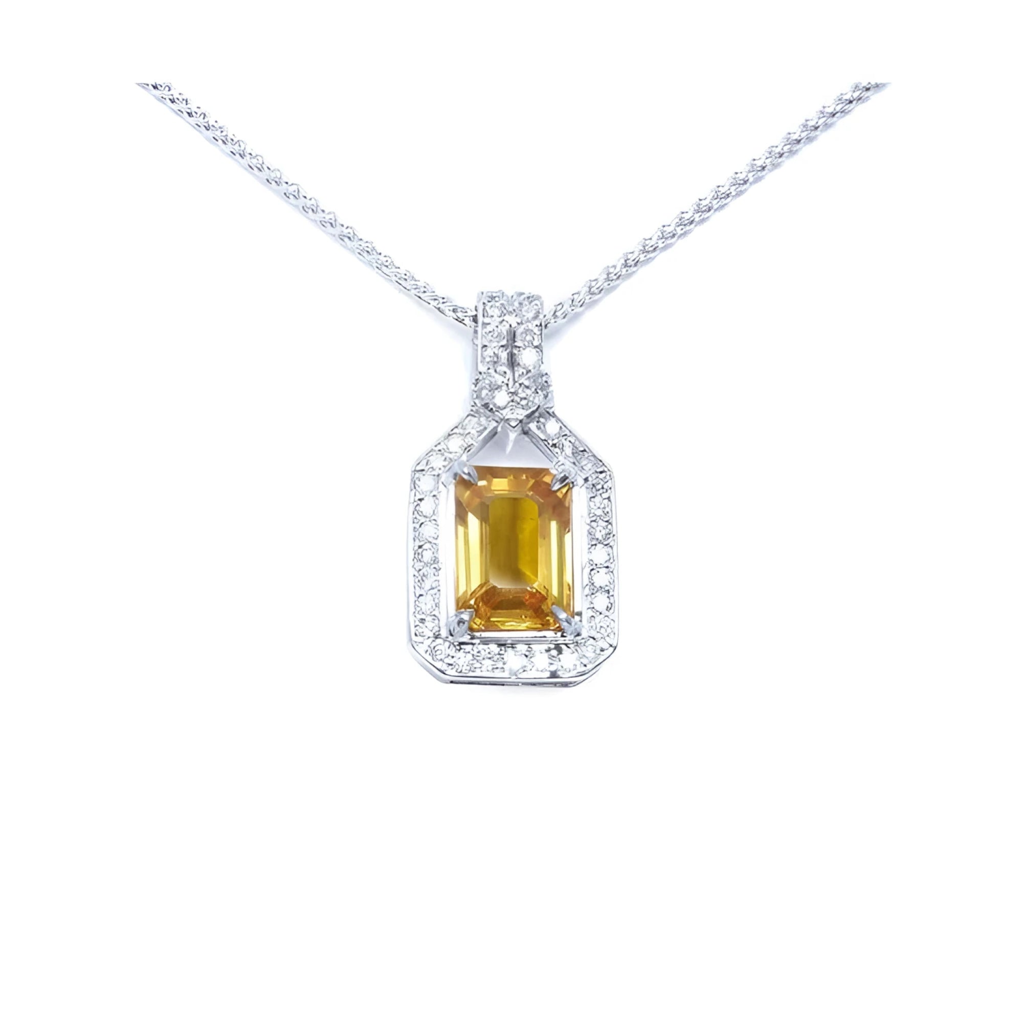 Emerald cut yellow sapphire pendant with halo diamonds on an 18K white gold chain.
