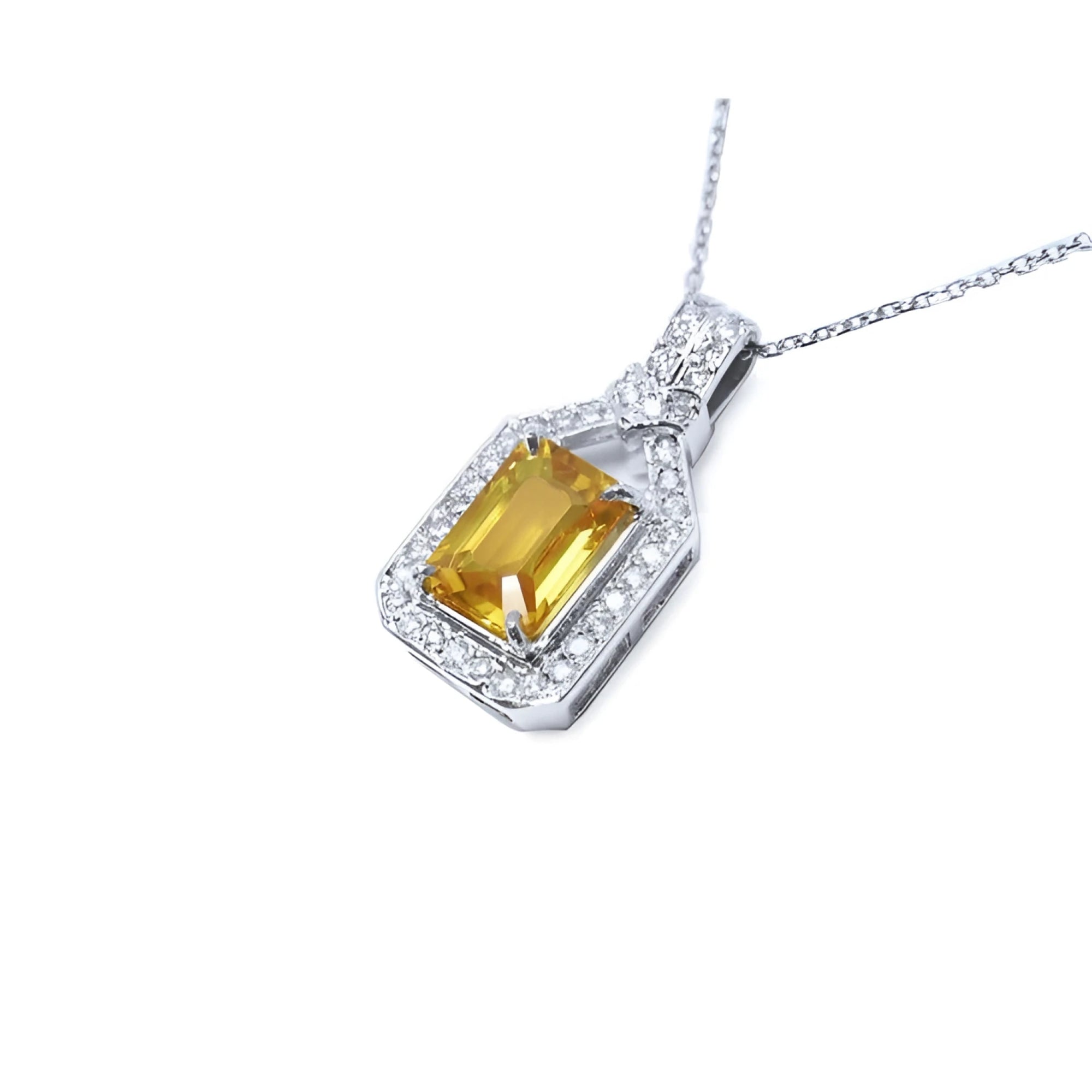 Emerald cut yellow sapphire pendant with halo diamonds on an 18K white gold chain.