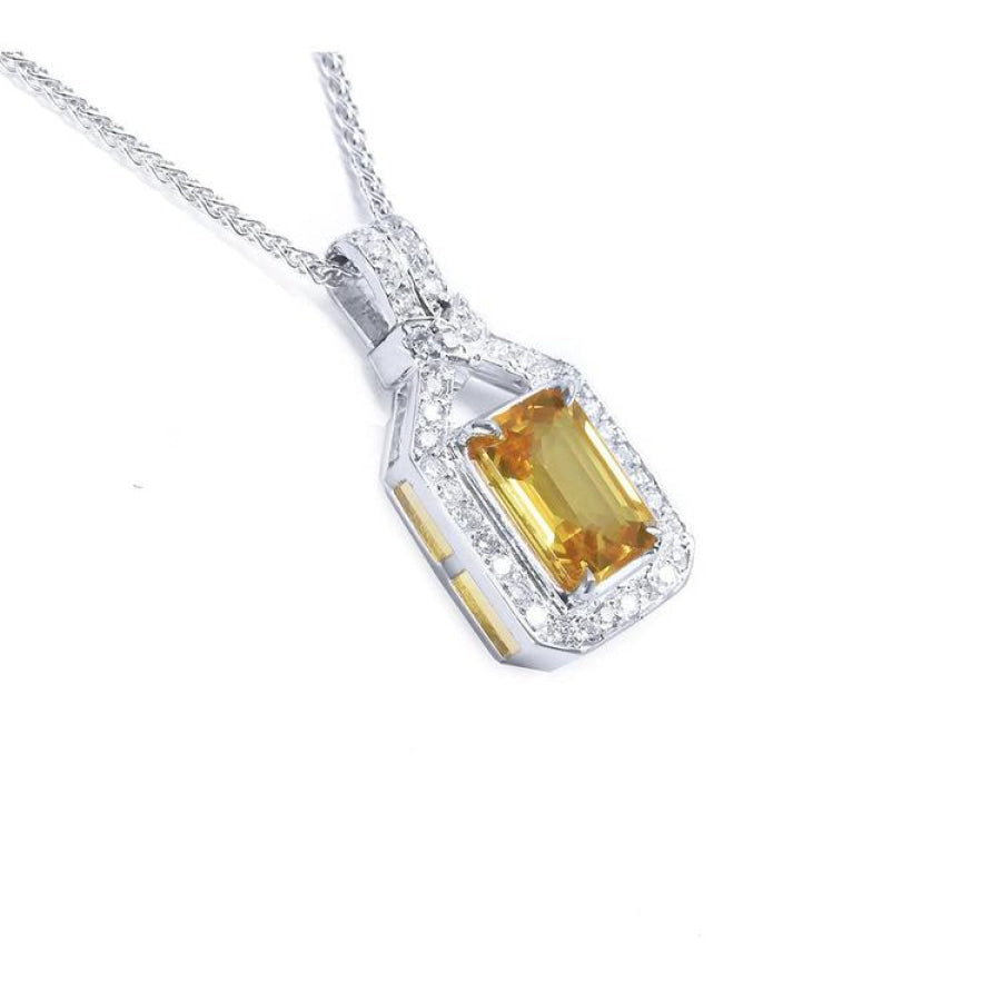 Emerald cut yellow sapphire pendant with halo diamonds in 18K white gold.