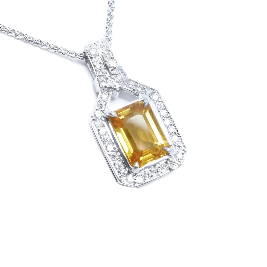Natural yellow sapphire pendant necklace, the gemstone displays a vibrant medium-deep yellow-orange hue halo diamond 18k white gold.