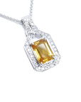 Natural yellow sapphire pendant necklace, the gemstone displays a vibrant medium-deep yellow-orange hue halo diamond 18k white gold.