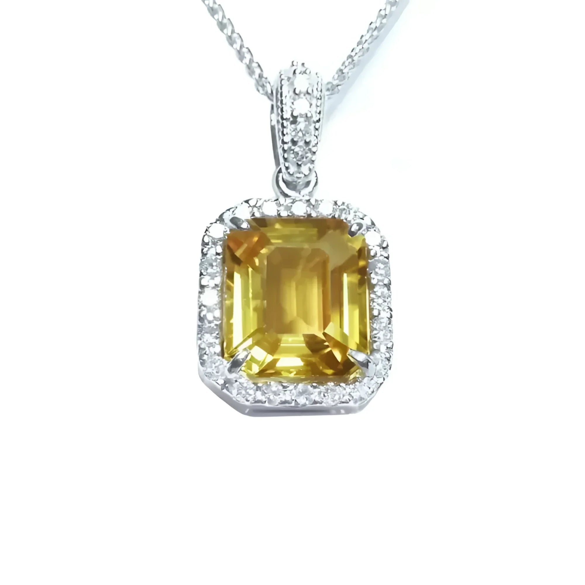 Natural yellow sapphire pendant showcasing a vibrant medium-light hue halo diamonds handcrafted in 18k white gold.