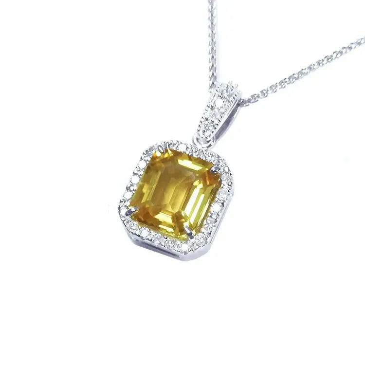 From the left angle of view a natural yellow sapphire pendant halo diamonds handcrafted in 18k white gold