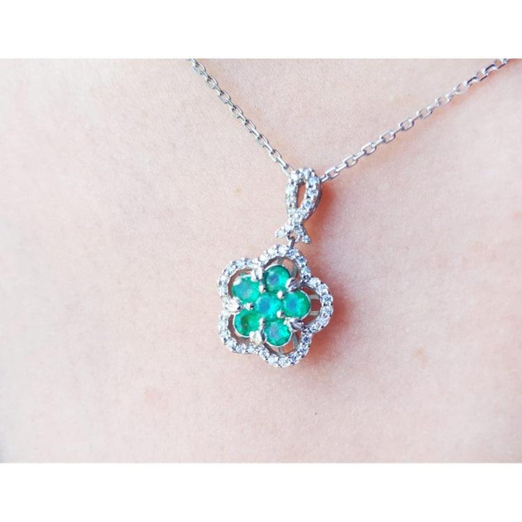 14K white gold emerald cluster necklace with diamond halo, clover-like five-petal design.