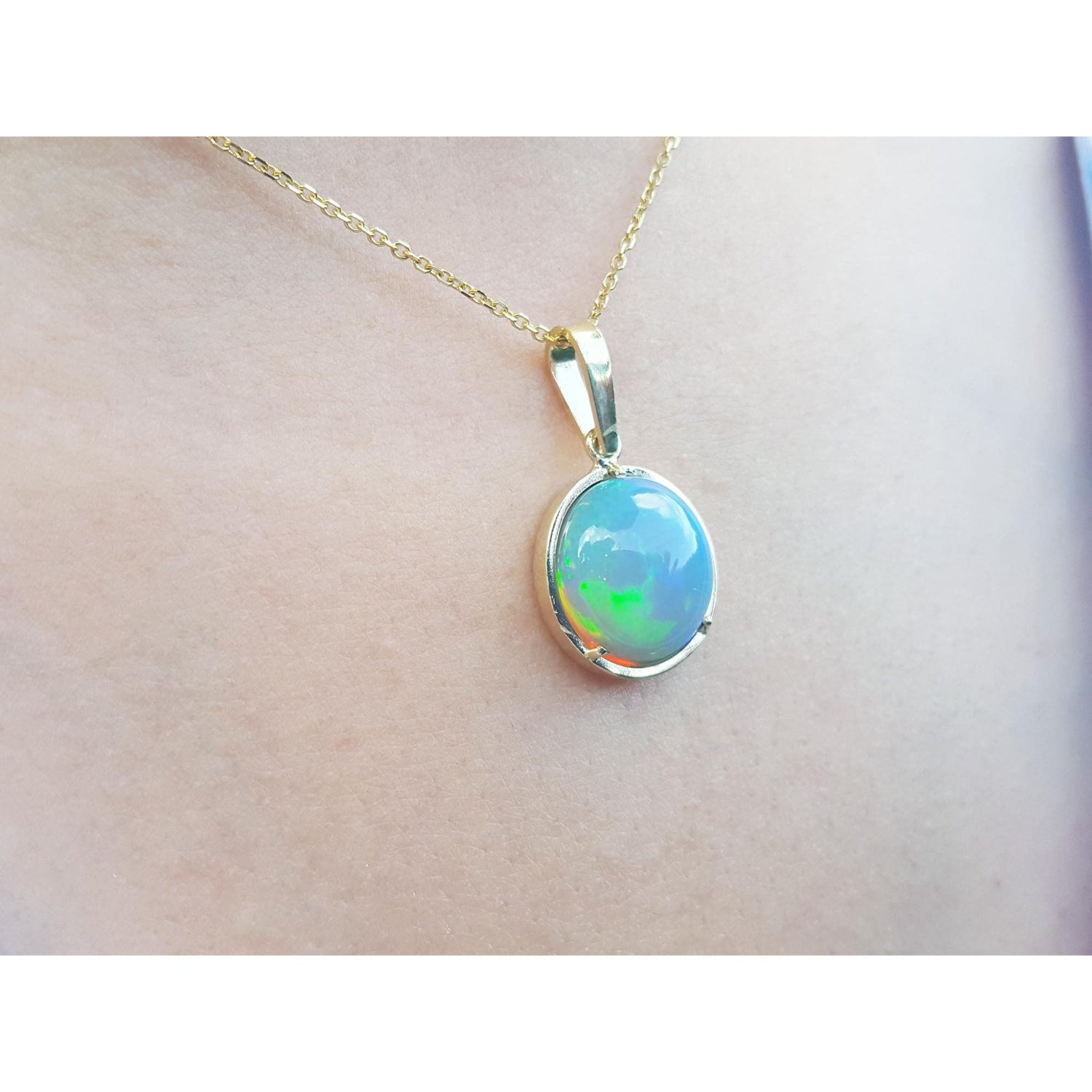 Opal pendant necklace on a plain skin background.