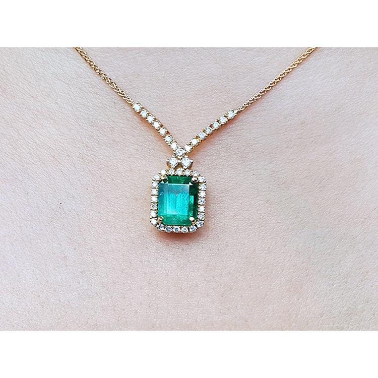 Emerald necklace with halo natural diamonds on a 14K yellow gold chain.