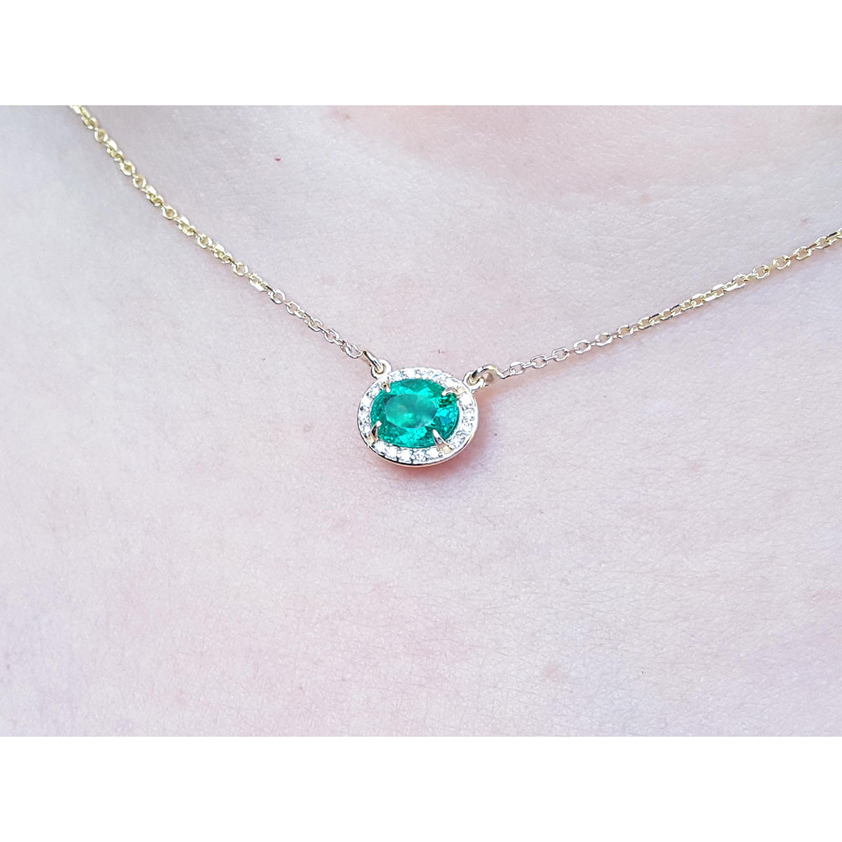 Oval cut east west orientation Emerald necklaces with a halo natural diamond, crafted in 14k yellow gold