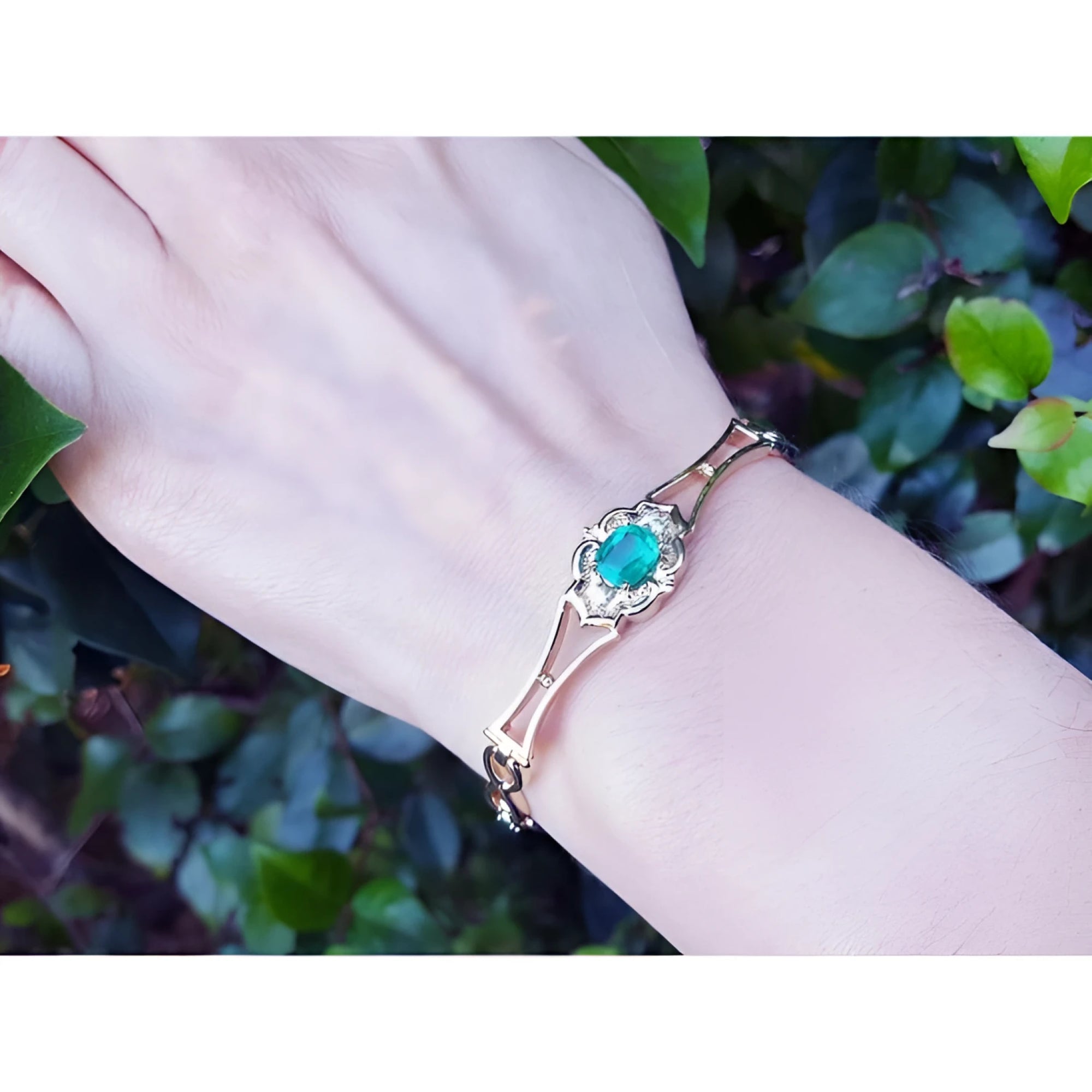 Women's 14K yellow gold bracelet with a central oval-cut natural emerald and sparkling green color.