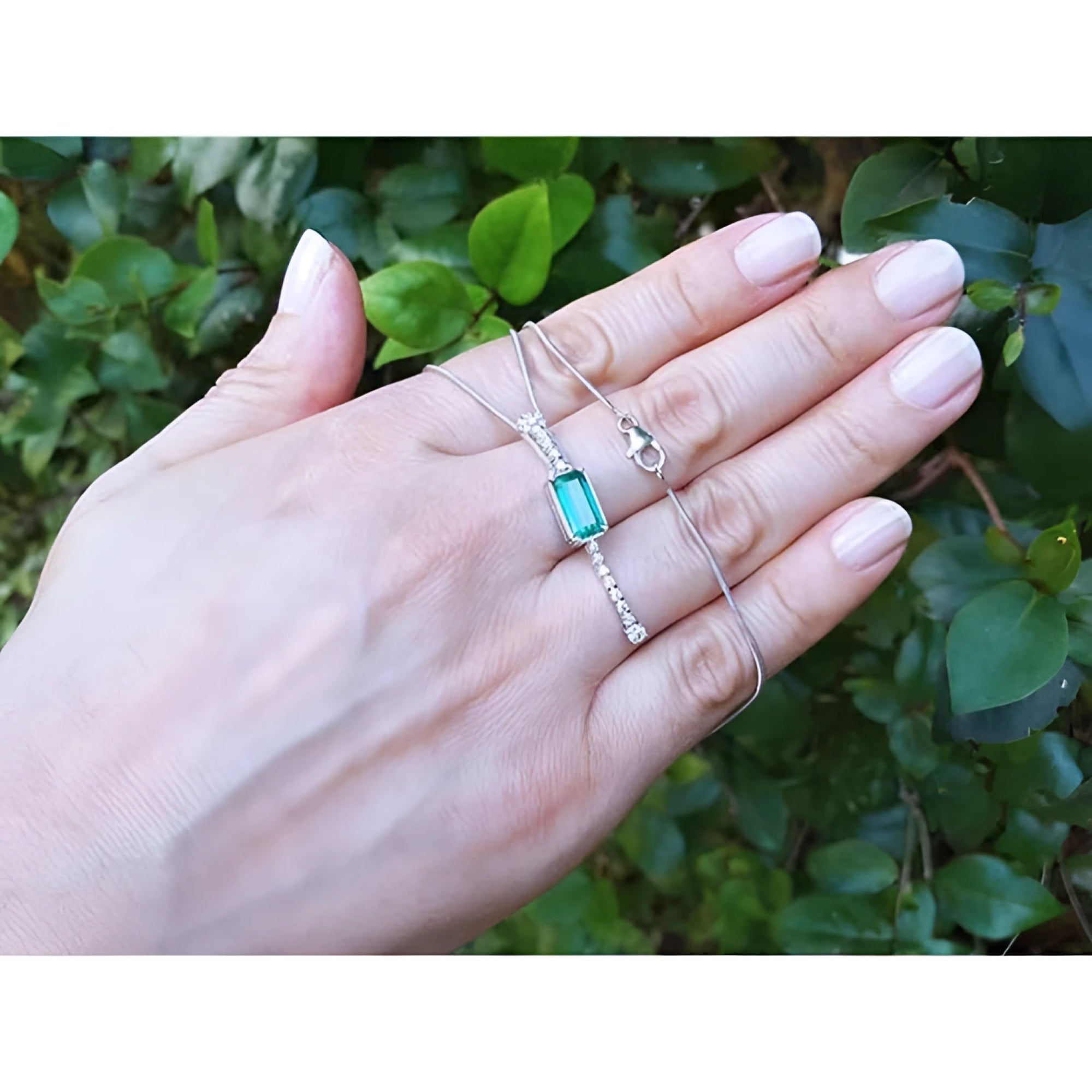 Women's 14K white gold necklace with a rectangular Colombian emerald and diamond accent.