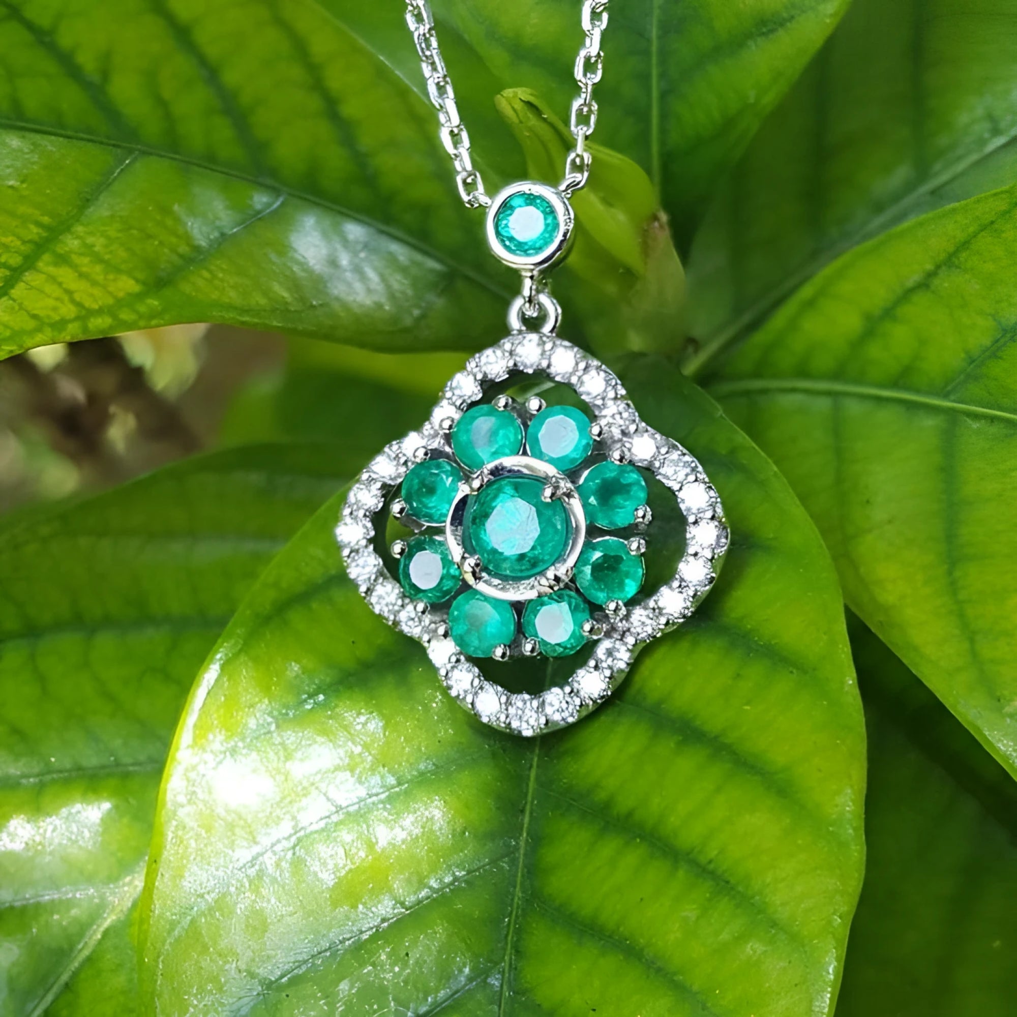 14K white gold cluster necklace with natural Colombian emeralds and diamond 4-leaf clover design.