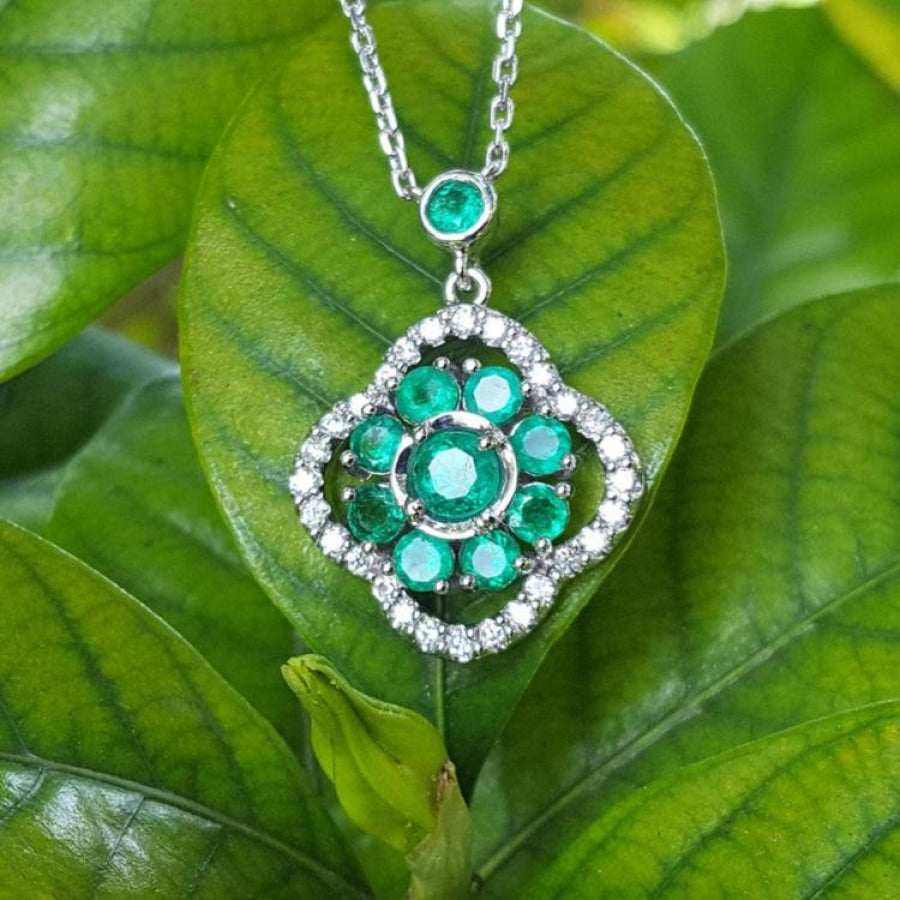 14K white gold cluster necklace with natural Colombian emeralds and diamond 4-leaf clover design on green leaves.