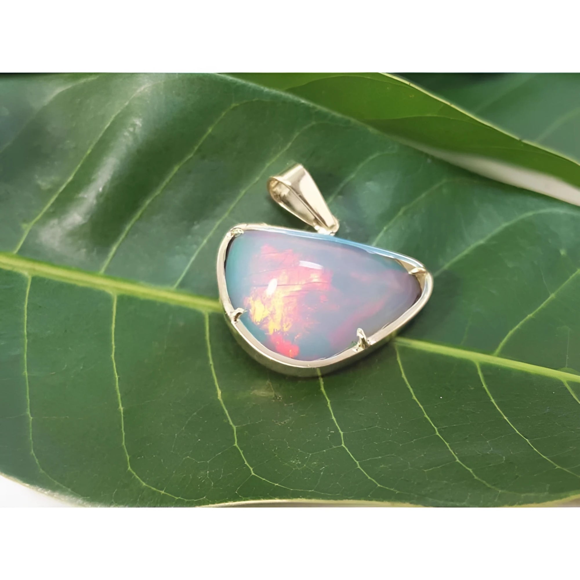 9.30 ct. Ethiopian opal necklace pendant in 14K yellow gold, showcasing red and orange fire.