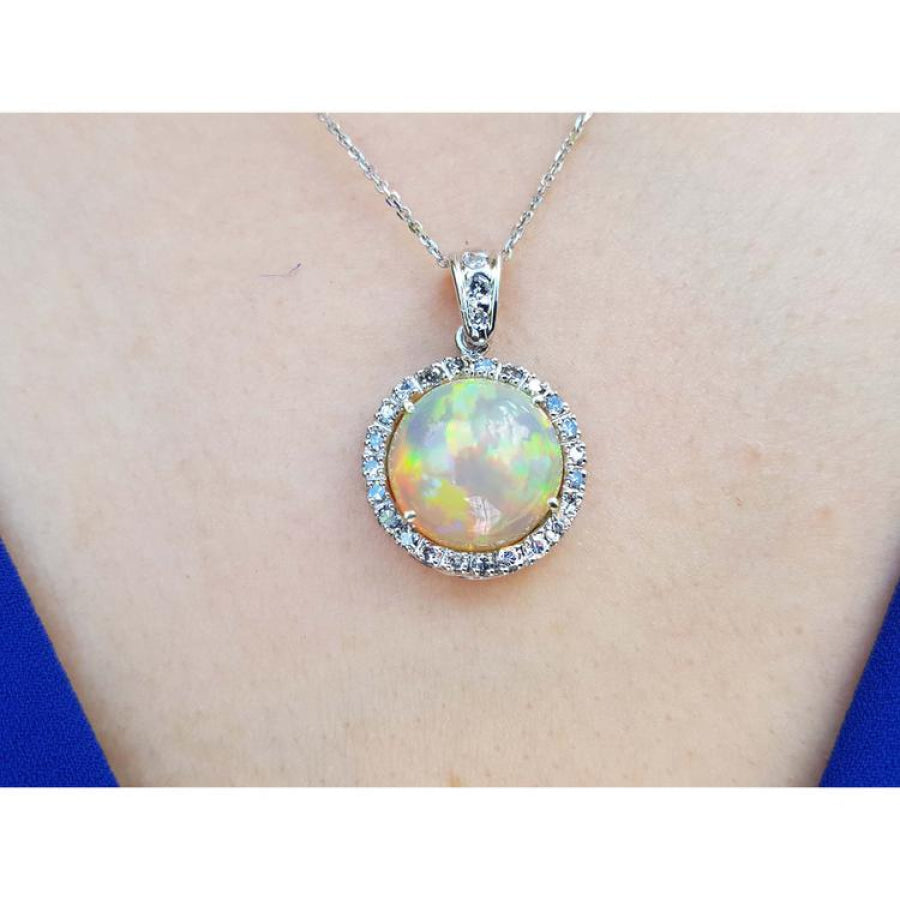 Ethiopian Welo opal and diamond pendant in 14K white gold, featuring a round opal with red flashes.