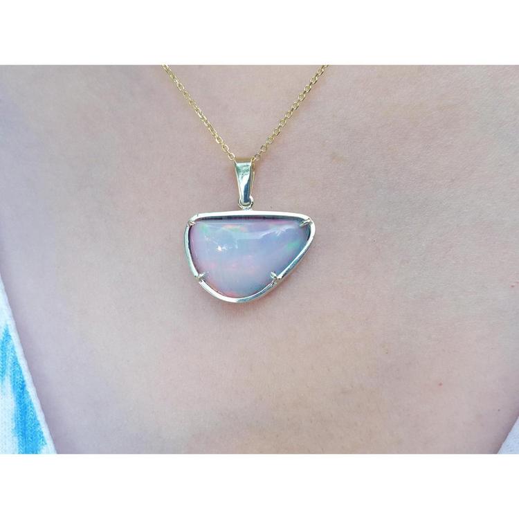 Ethiopian opal necklace pendant with red/orange fire, free-form cabochon, 14K yellow gold setting.