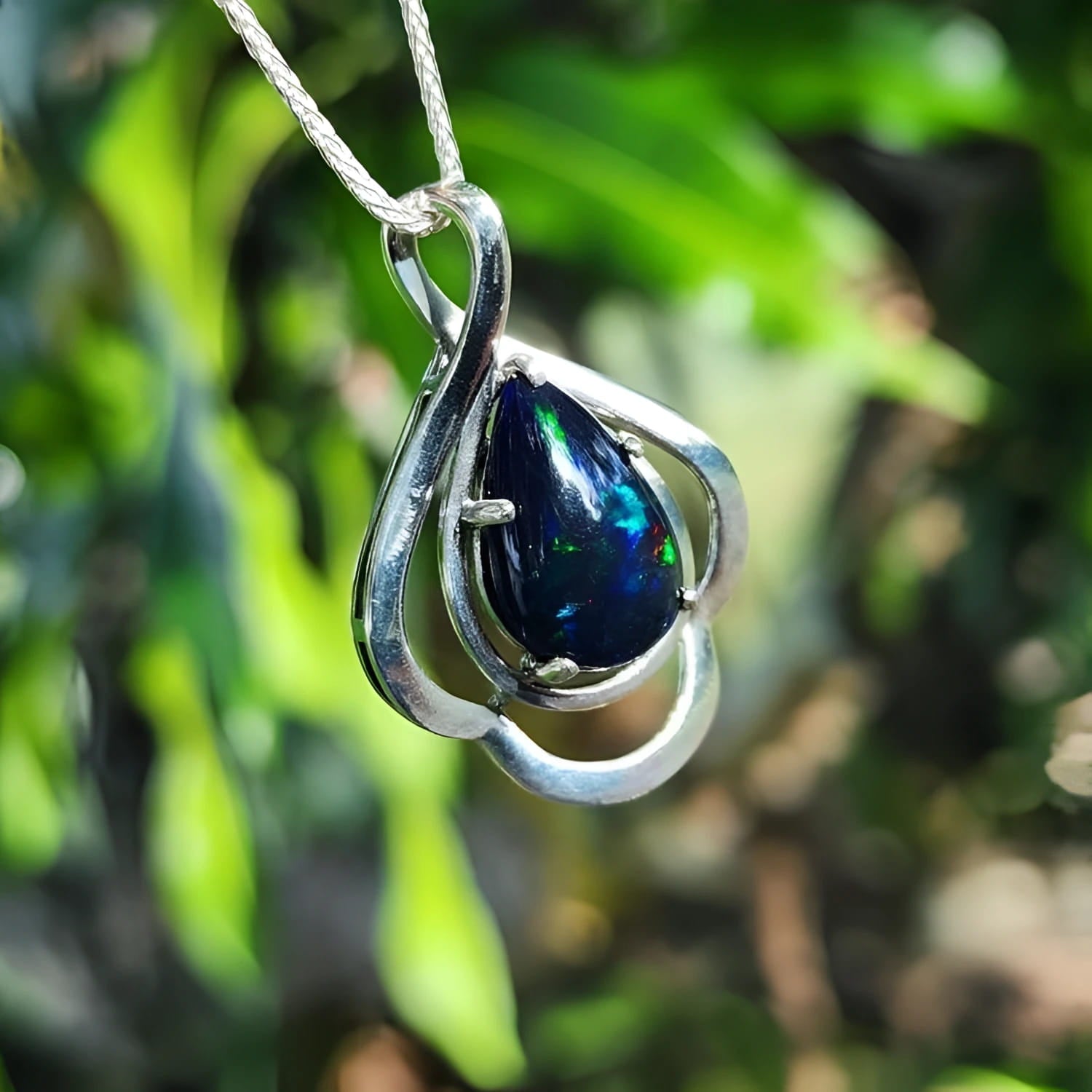 Teardrop 4.30 ct Ethiopian black opal pendant in sterling silver with multicolor flashes.