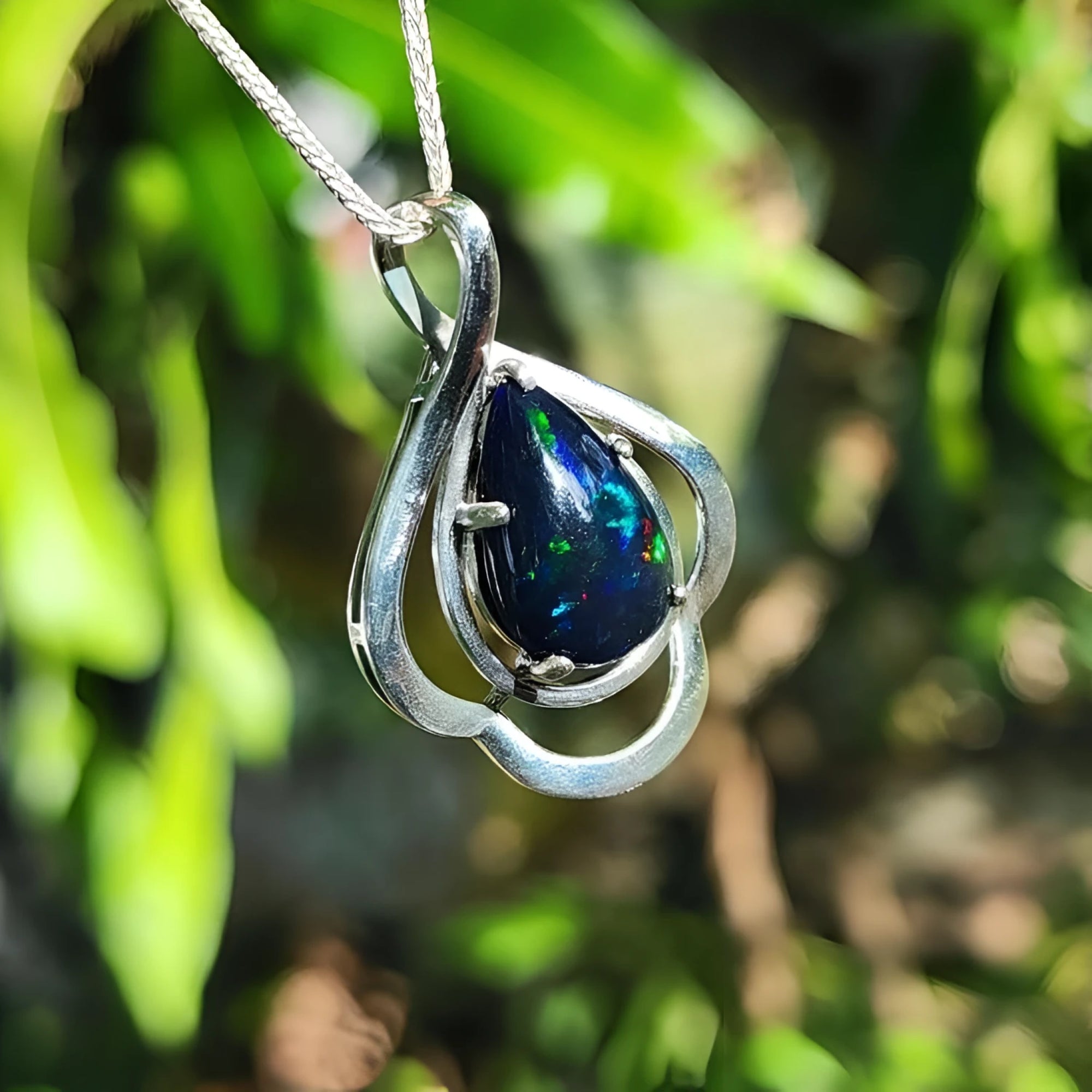 4.30 ct. teardrop Ethiopian black opal pendant in sterling silver with multicolor flashes.