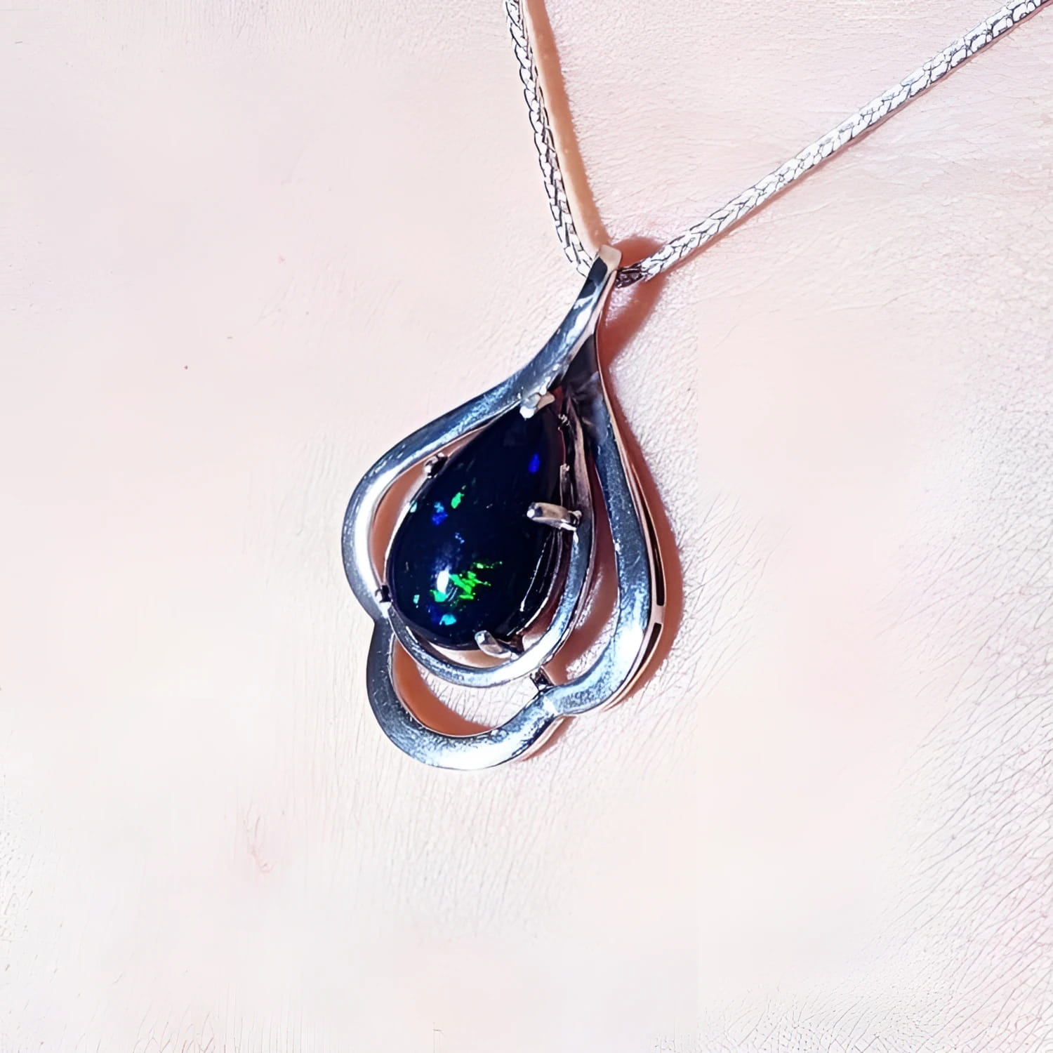 4.30 ct teardrop Ethiopian black opal pendant in sterling silver with multicolor flashes.
