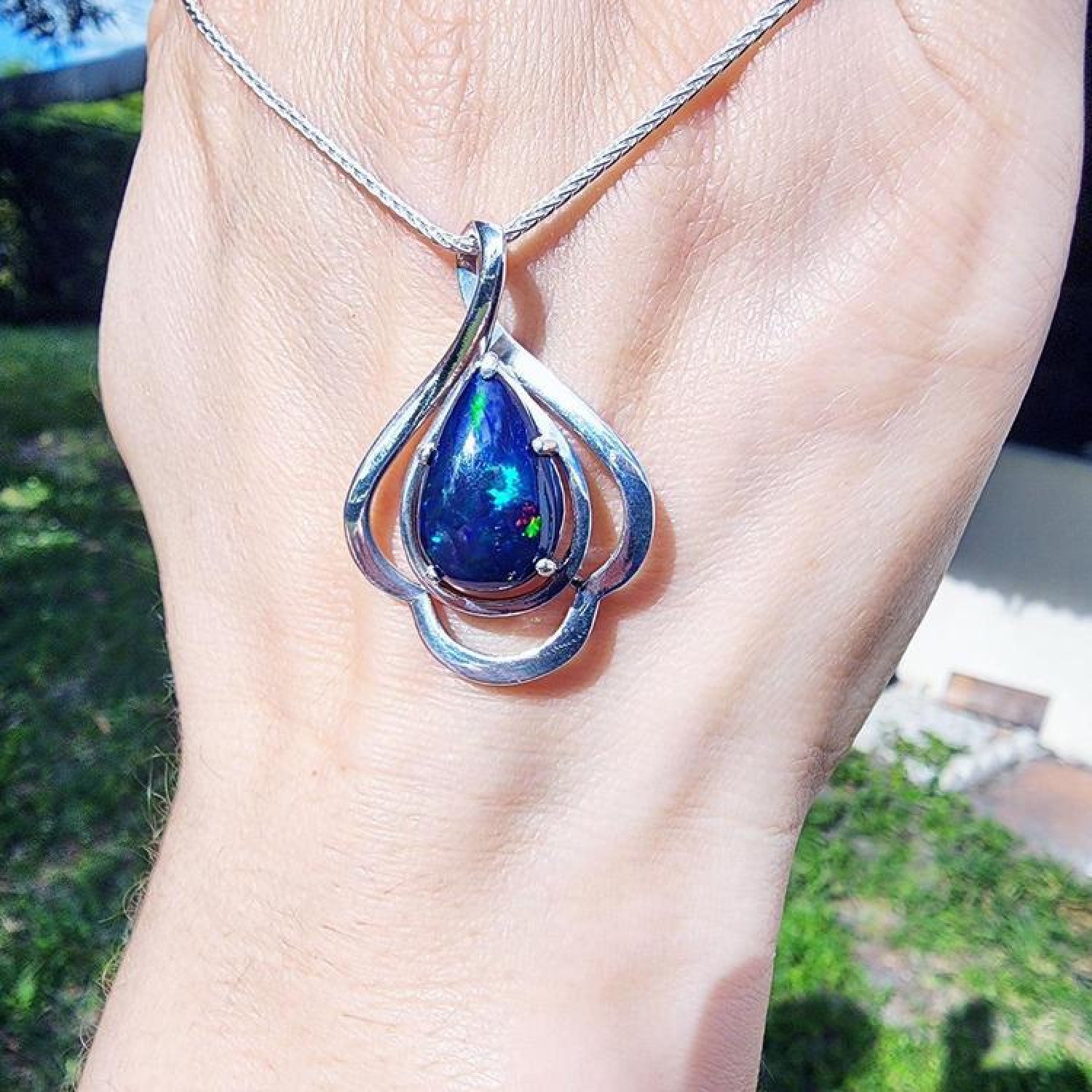 Teardrop 4.30 ct Ethiopian black opal pendant in sterling silver with multicolor flashes.