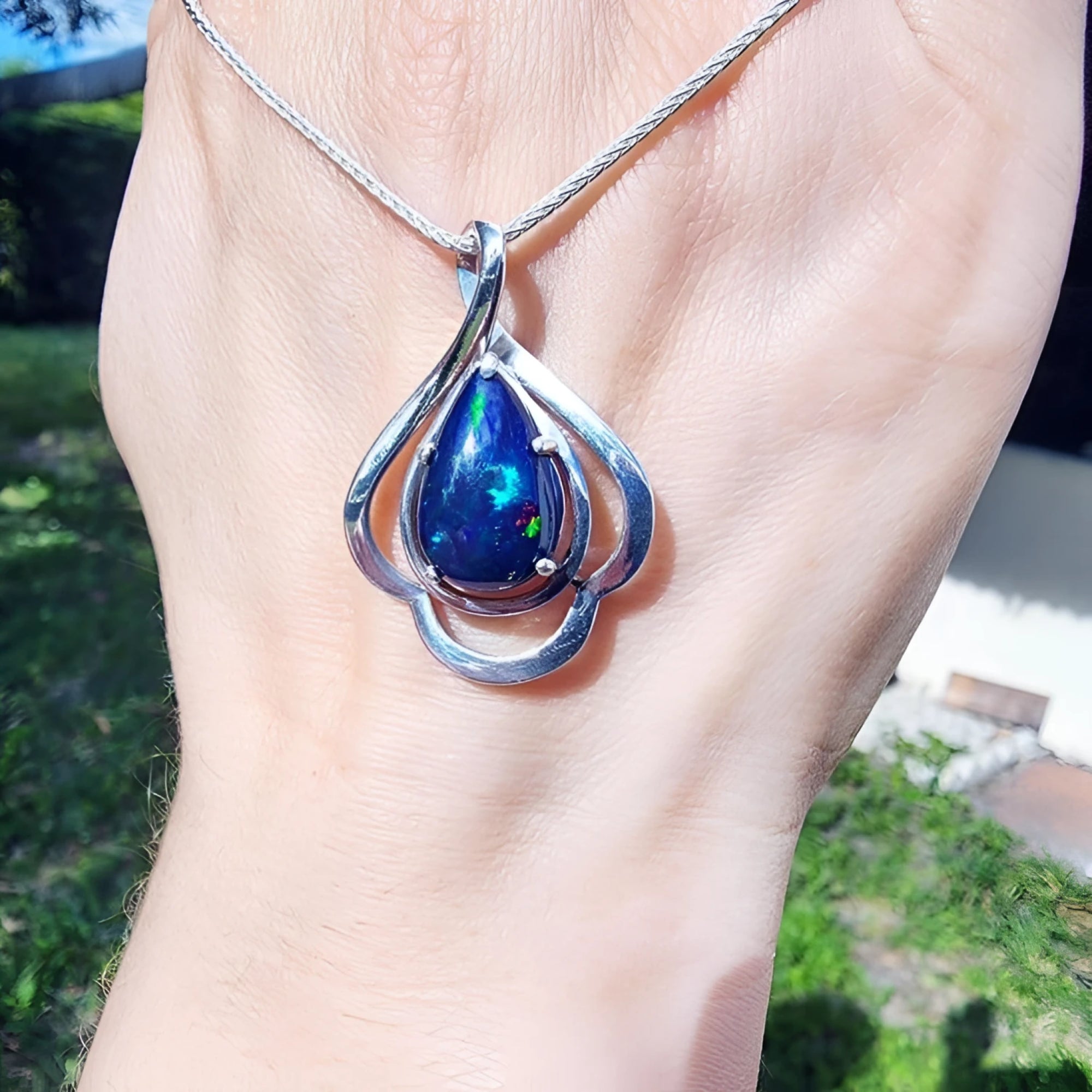 Teardrop 4.30 ct Ethiopian black opal pendant in sterling silver with multicolor flashes.
