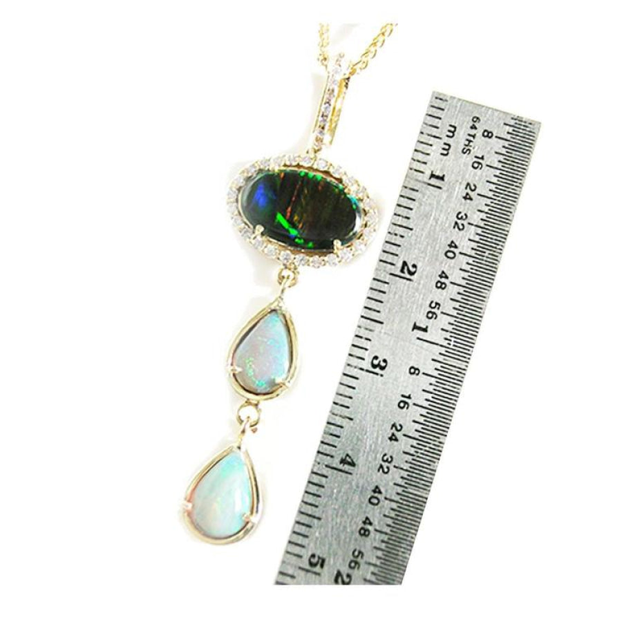 Black and white Australian opal pendant in 14K yellow gold with diamond halo and two teardrop opals.