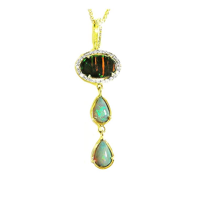 The topside view of an opal pendant necklace with gold setting on a white background.