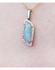 Opal pendant necklace on a pink background