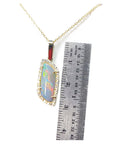 Opal pendant necklace with a ruler for scale on a white background