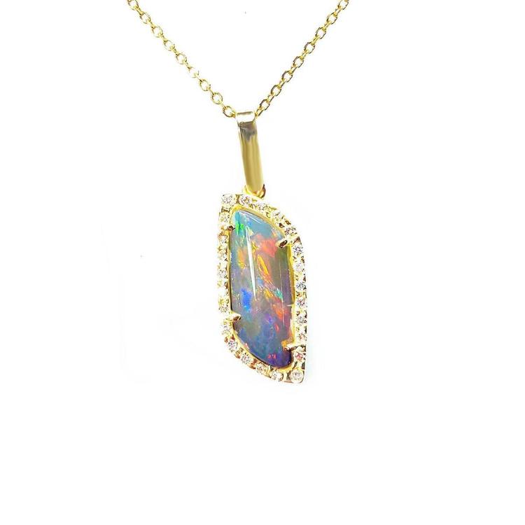 Opal pendant necklace with gold chain on a white background