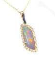 Opal pendant necklace with gold chain on a topside view