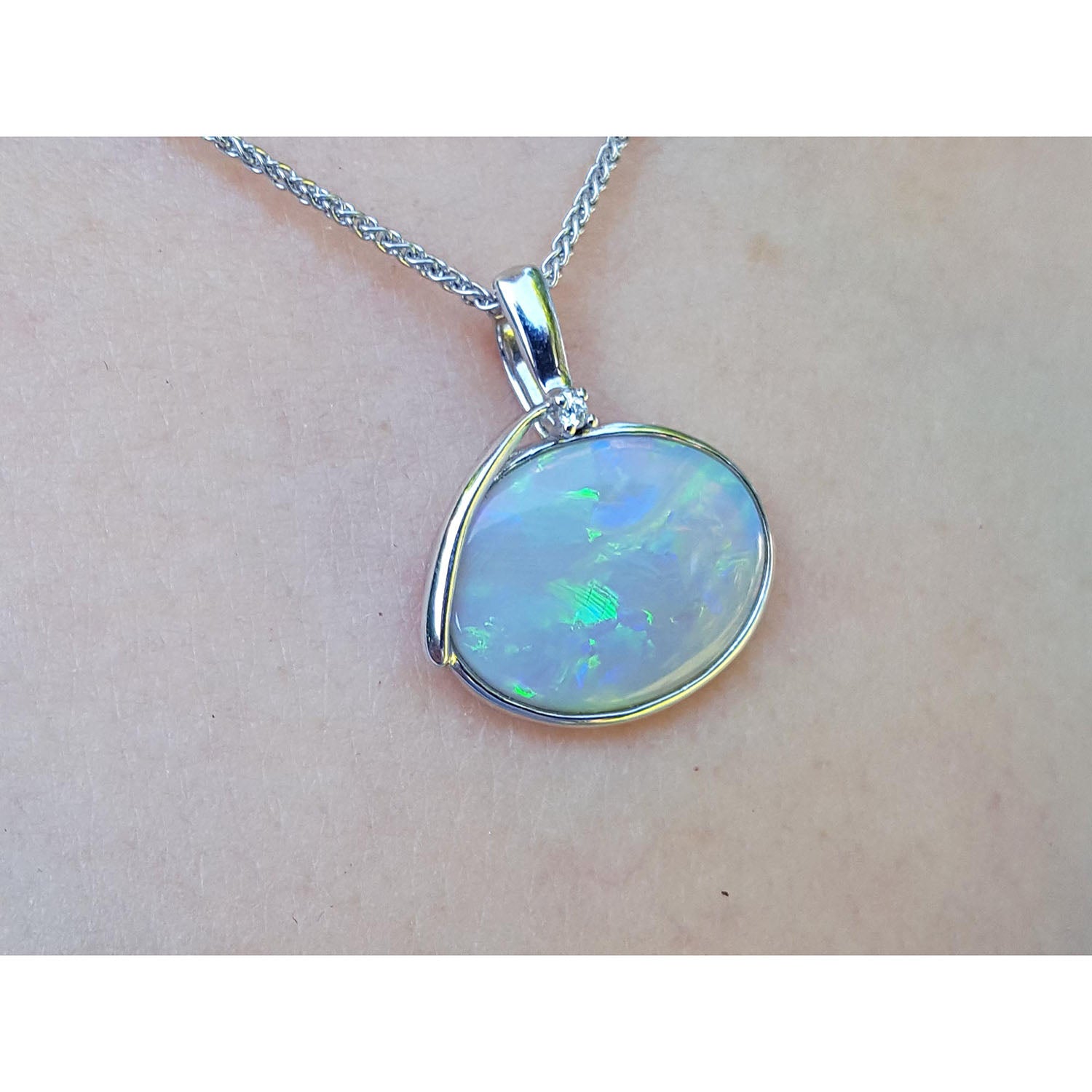 Opal pendant necklace on a person&#39;s neck with a white background