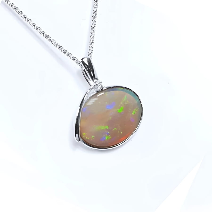 2.25 ct Australian opal pendant in 14K white gold, east-west bezel set, with bluish-green flashes.
