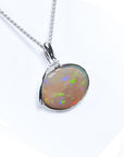 A natural Australian opal pendant necklace on a white background