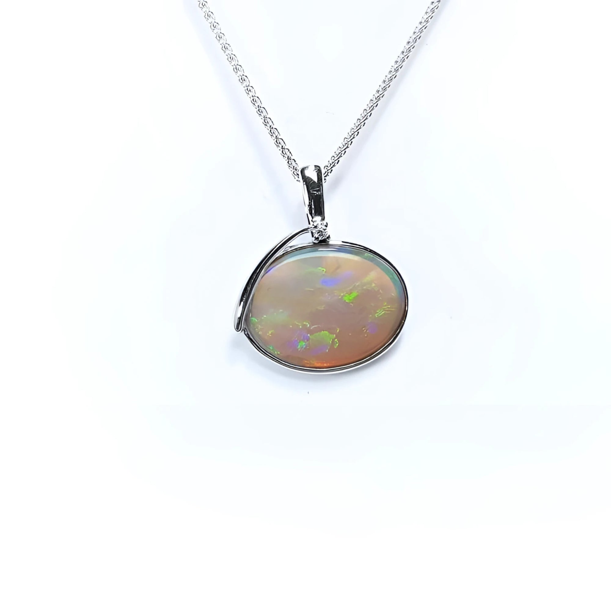 2.25 ct. Australian opal pendant in 14K white gold, east-west bezel set with bluish-green flashes.