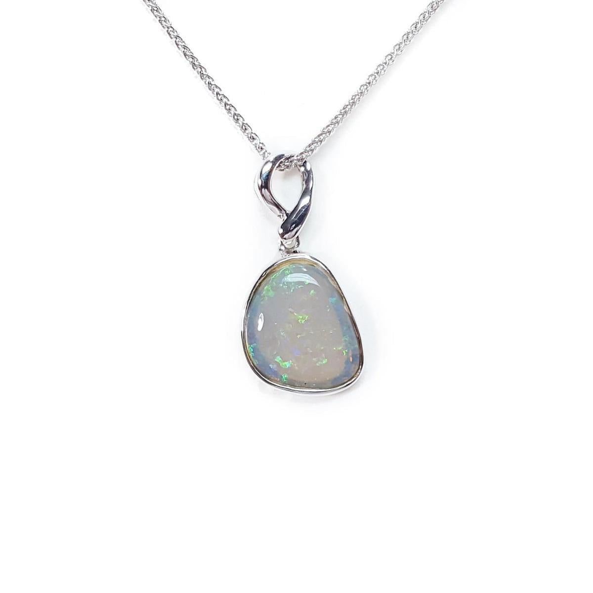 Opal pendant on a white gold chain against a white background