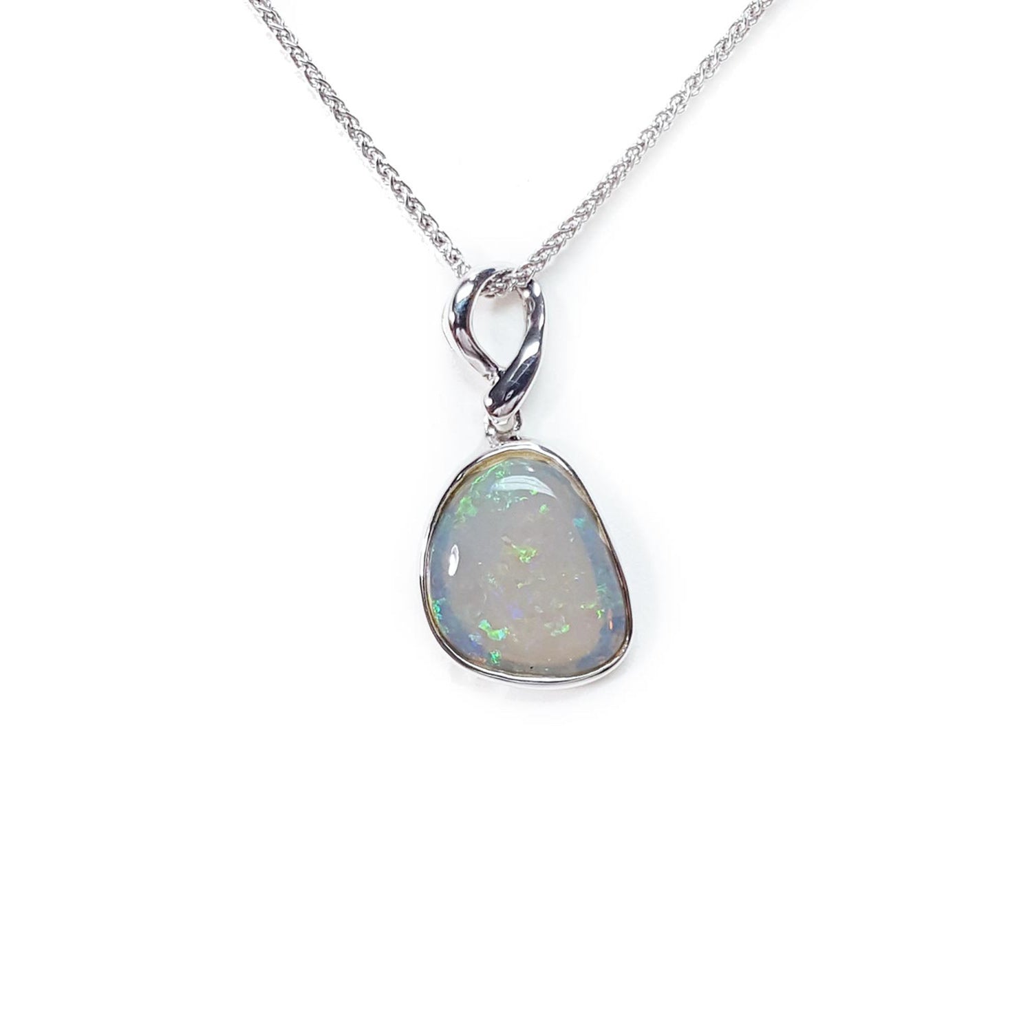 Opal pendant on a white gold chain against a white background