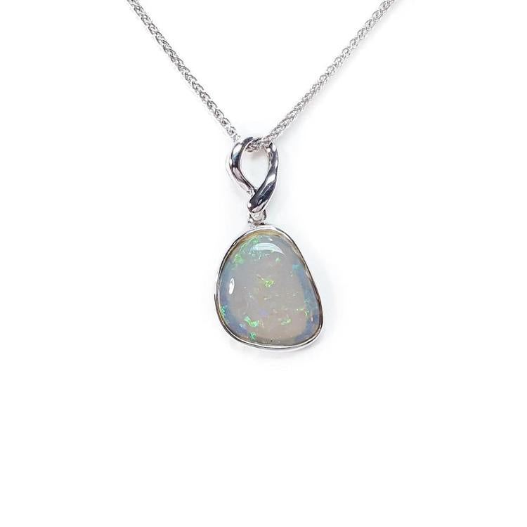 Opal pendant on a white gold chain against a white background