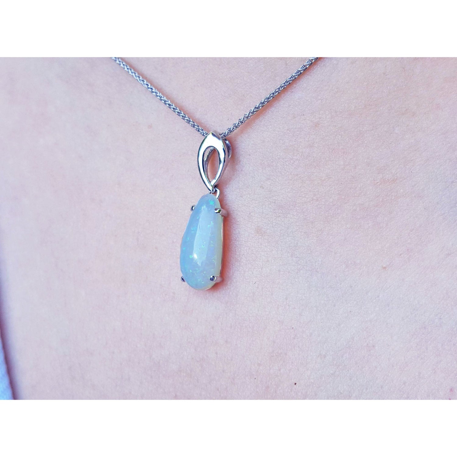 Necklace with a light blue pendant on a person&#39;s neck