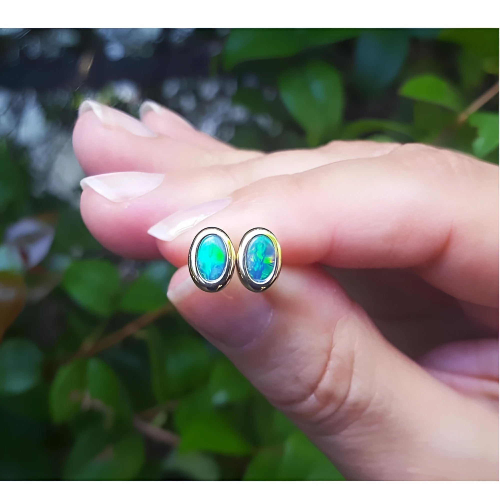 14k yellow gold oval stud earrings with sparkling blue Australian opal doublets, bezel set.