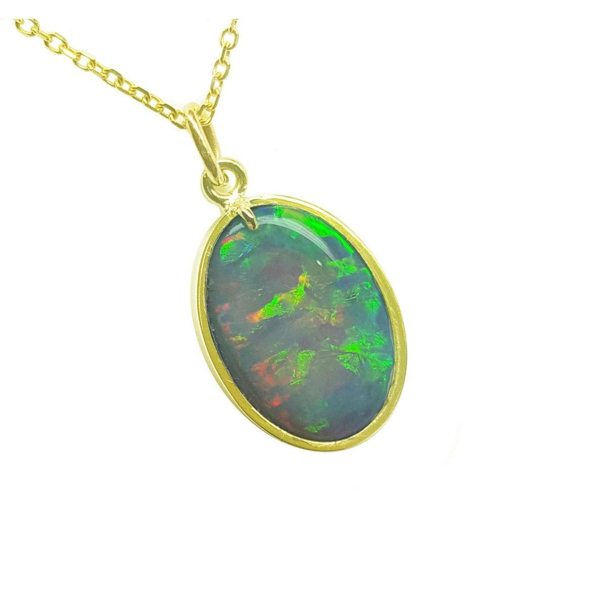 Opal pendant with gold frame on a white background