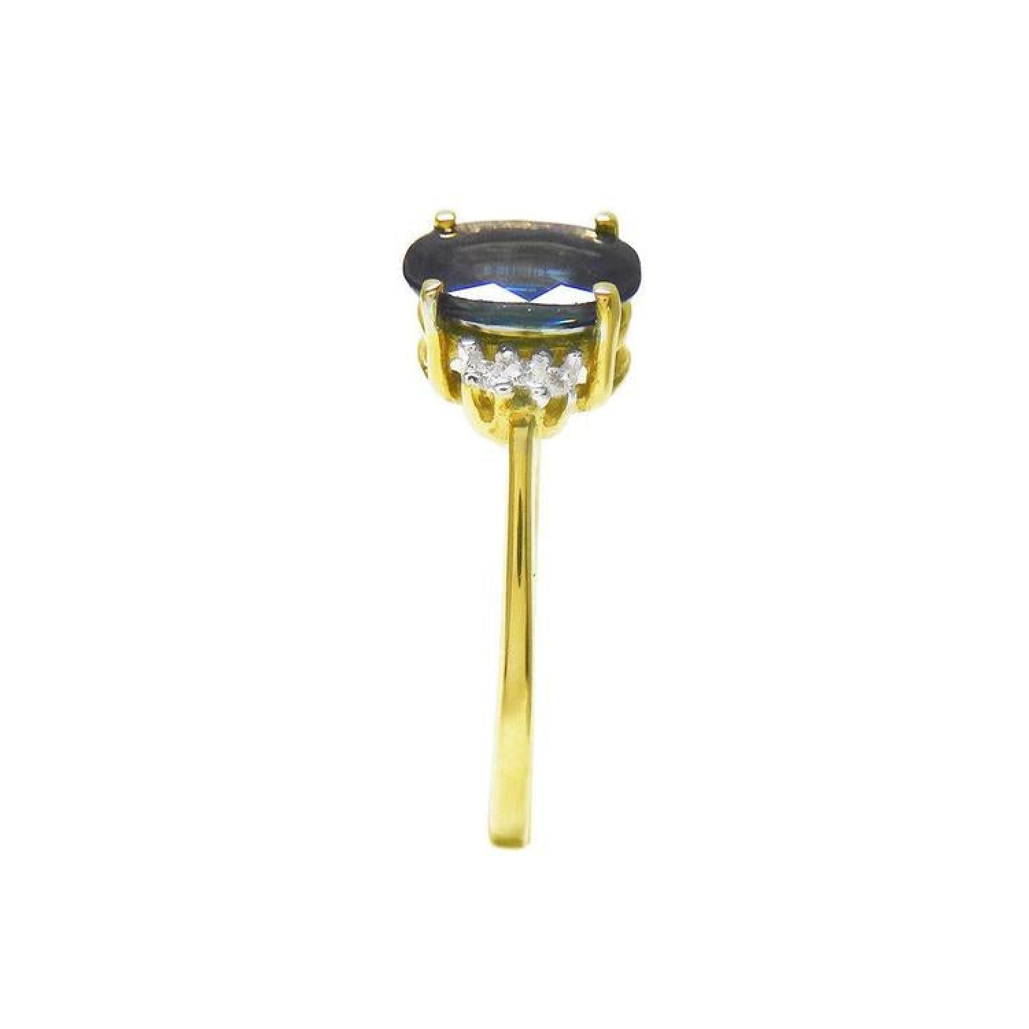 14K yellow gold ring with a prominent oval blue sapphire and two small diamonds on each side.