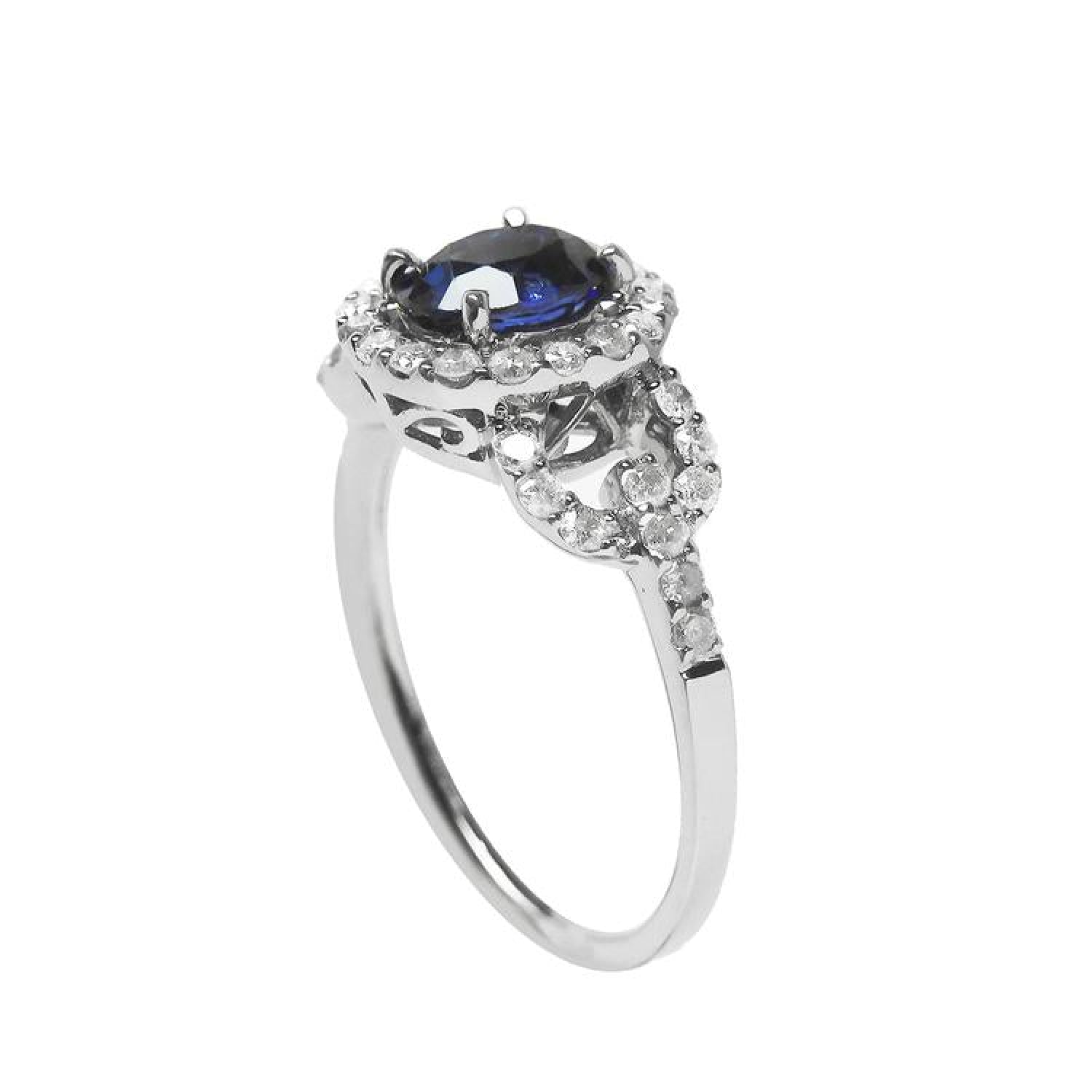 1.08 ct oval blue sapphire ring in 14K white gold with diamond halo and accents.