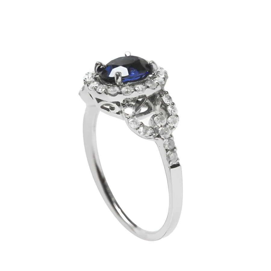 1.08 ct oval blue sapphire ring in 14K white gold with diamond halo and accents.