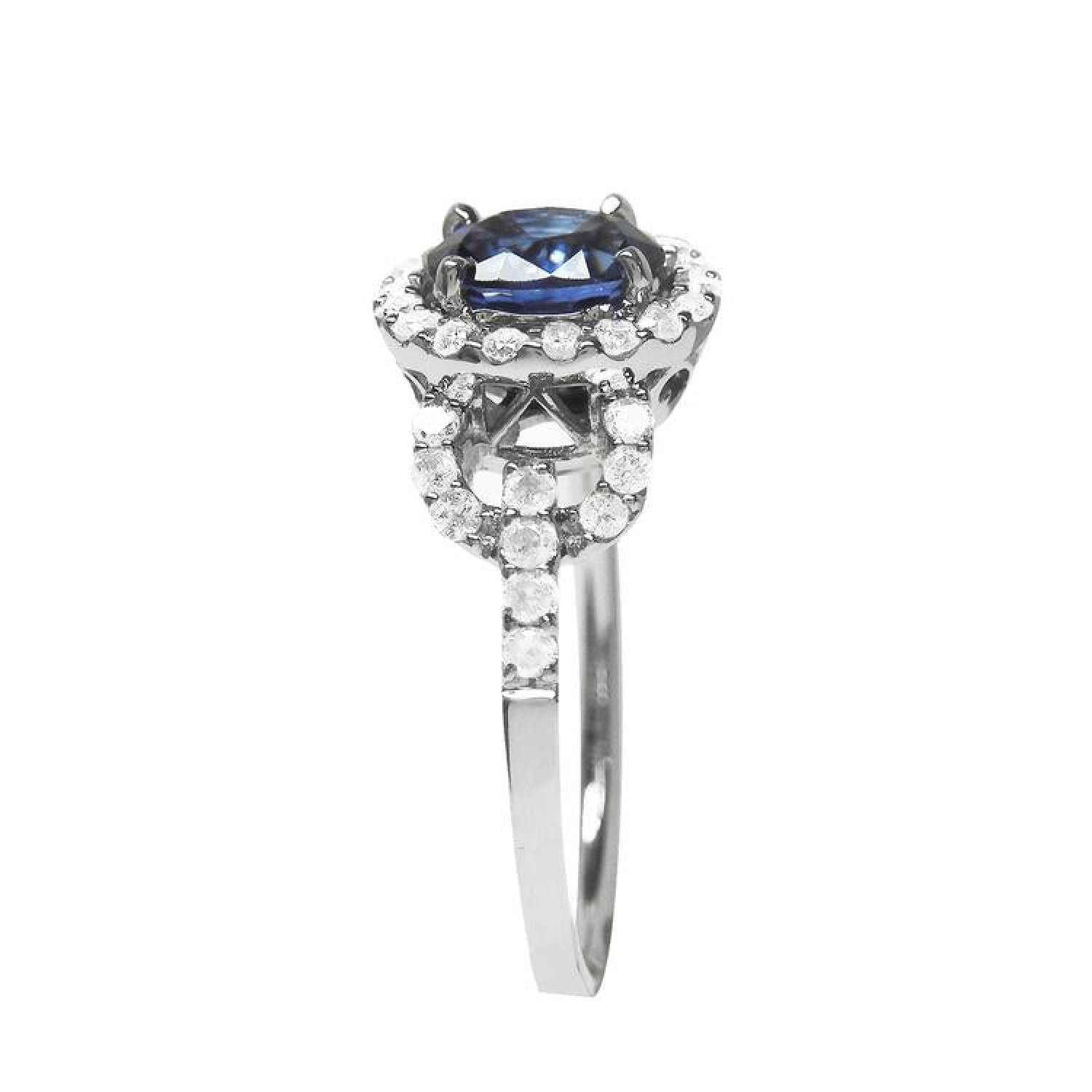 1.08 ct oval blue sapphire ring in 14K white gold with diamond halo.