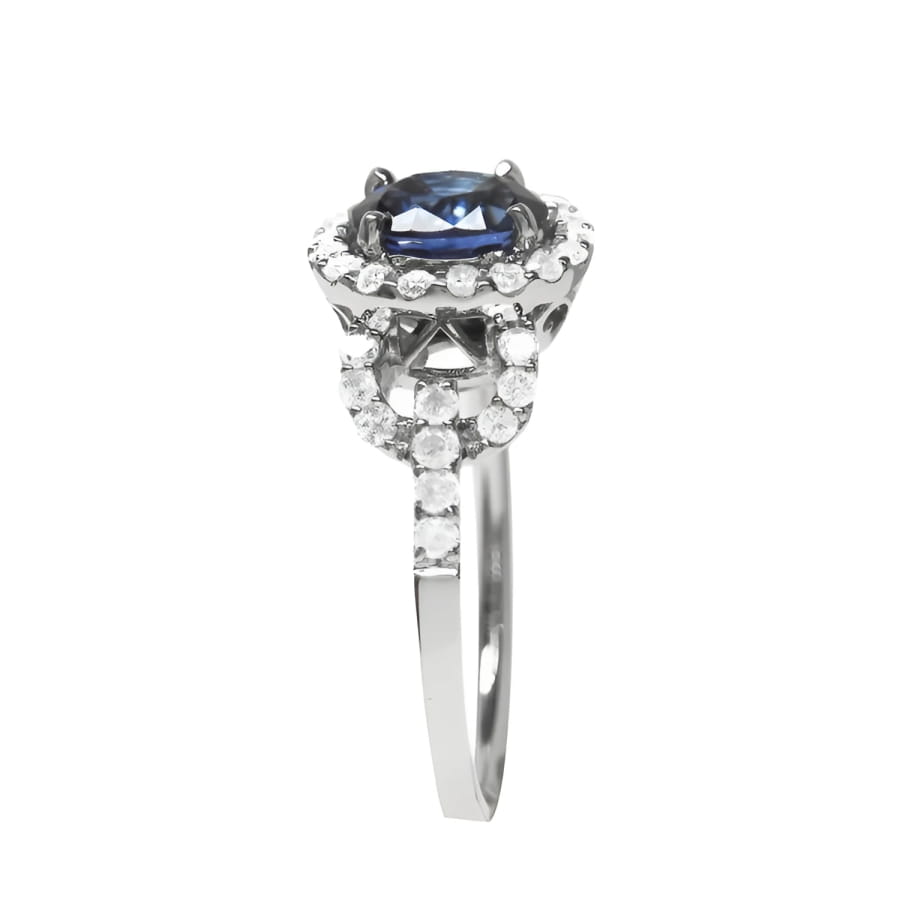 1.08 ct oval blue sapphire ring in 14K white gold with diamond halo.