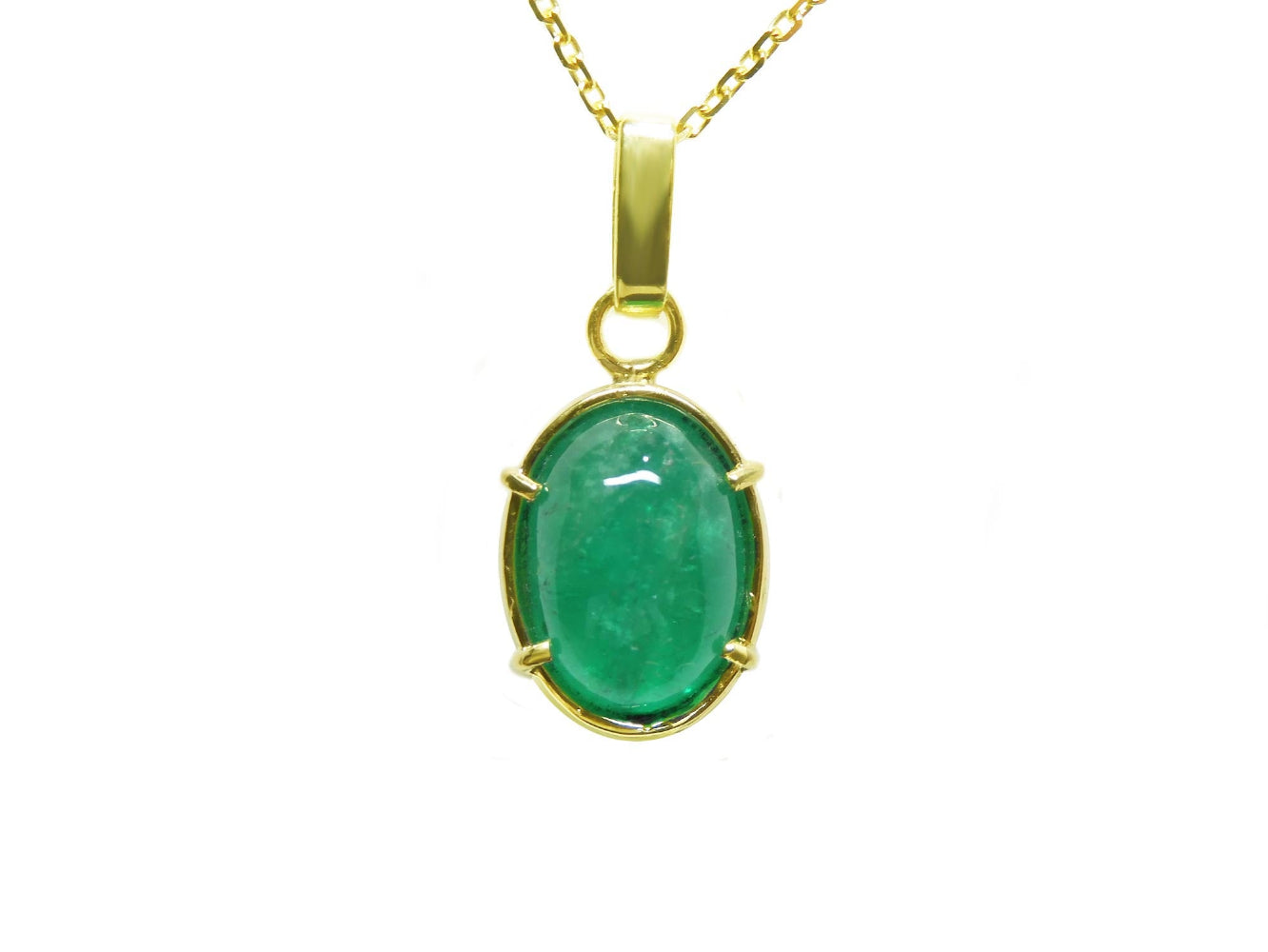 A cabochon emerald pendant on a yellow gold chain topside display.