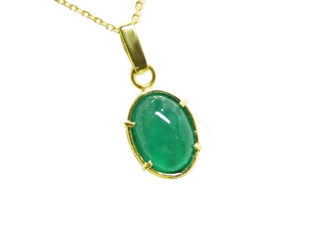 Gold pendant with a natural cabochon emerald pendant topside view.