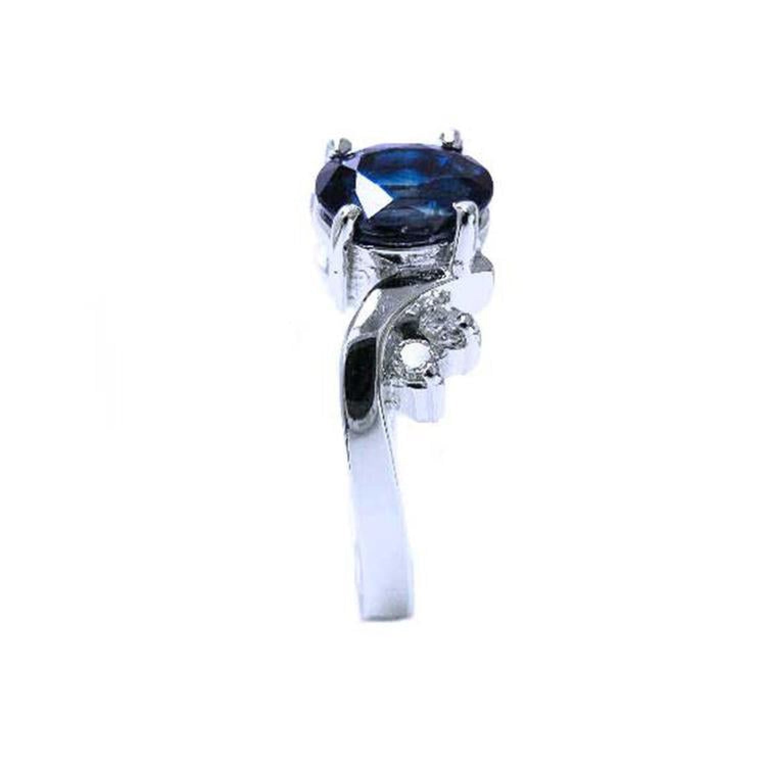 14K white gold ring with a 1.43 ct oval deep blue sapphire and accent diamonds.