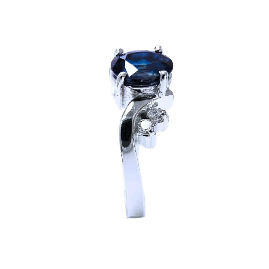 14K white gold ring with a 1.43 ct oval deep blue sapphire and accent diamonds.