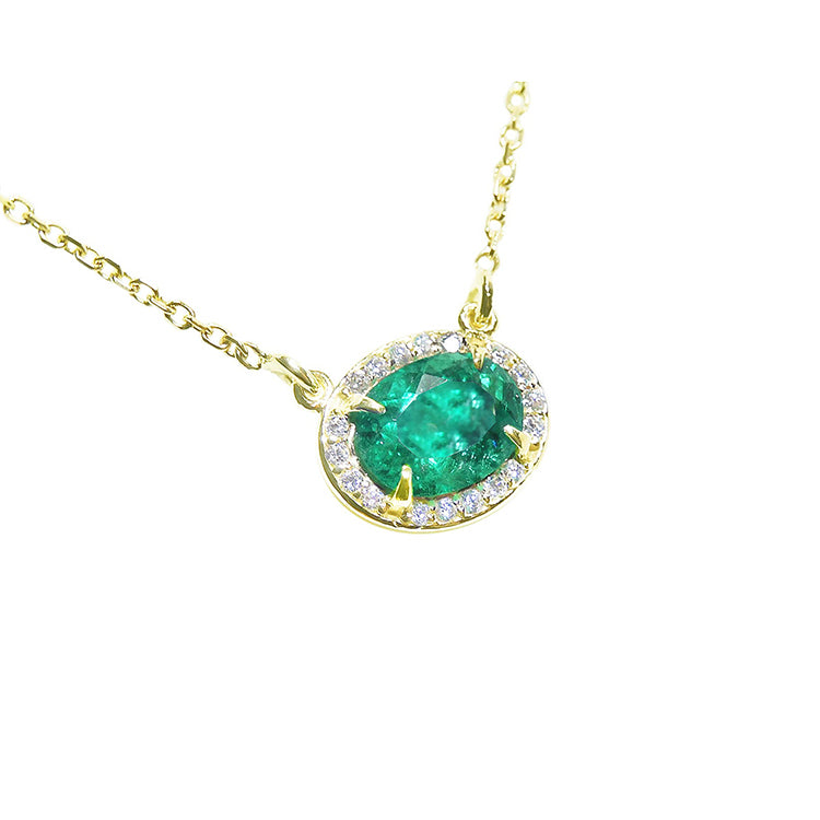 Emerald necklace oval cut east west orientation from Muzo mines Colombia halo natural diamonds, crafted in 14k yellow gold 